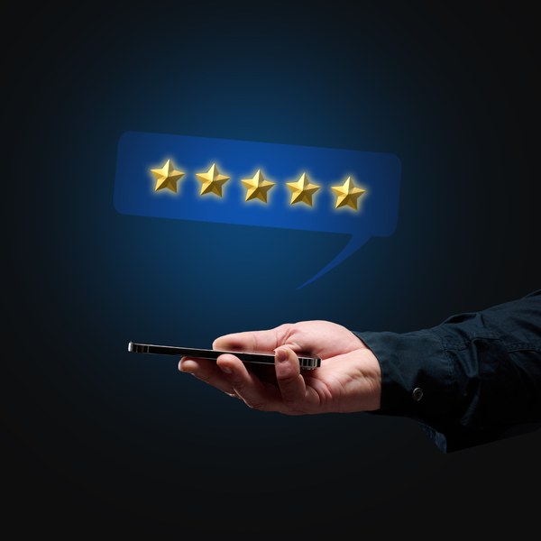 Five star customer review shown above a smartphone