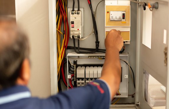 An electrician testing a consumer unit