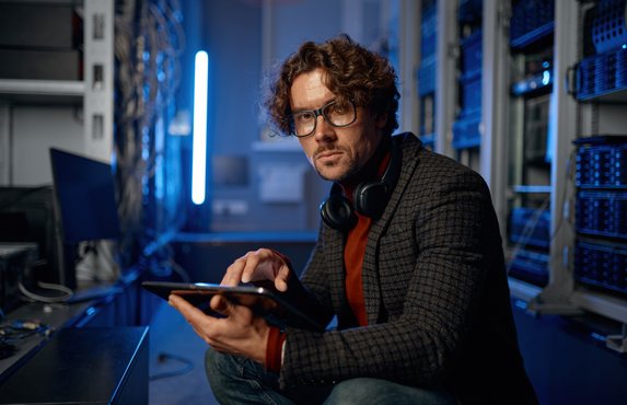 An IT technician checking servers in a data room