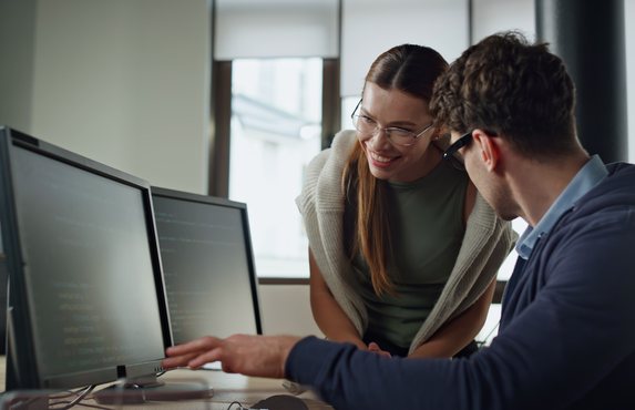 Colleagues working through a problem together on screen