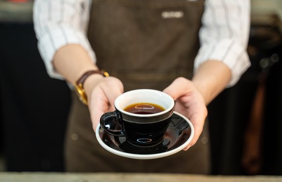 Coffee served at the counter in a busy cafe